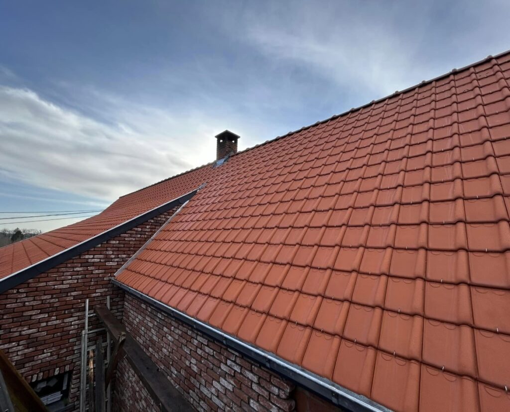 Toiture en tuiles rouges installée par un couvreur dans le Nord de la France près de Lille